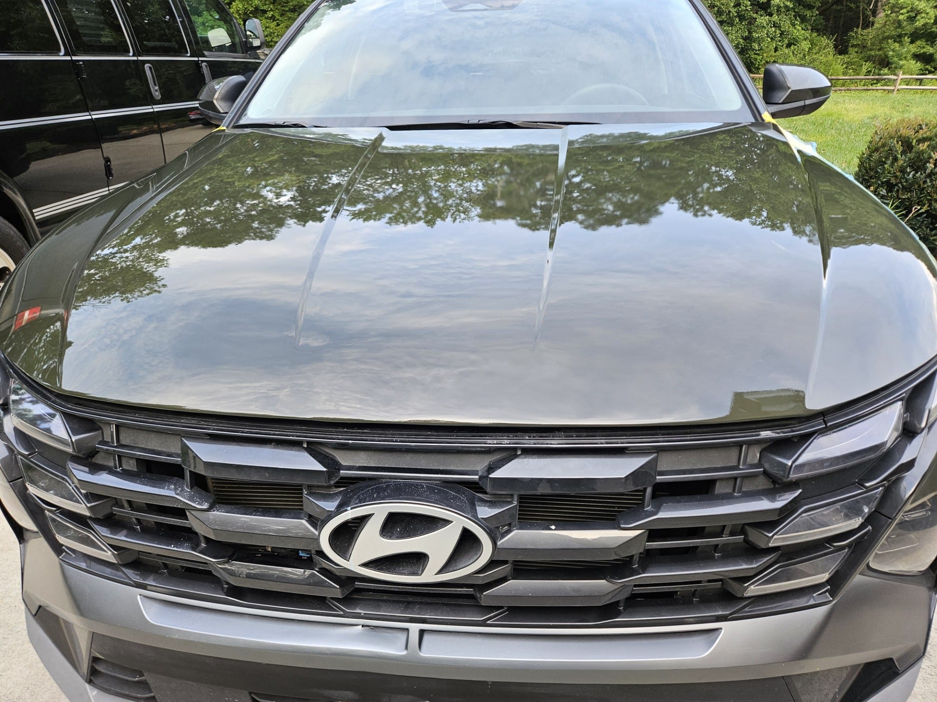 After photo of gray Hyundai Tucson hood repaired and refinished with a flawless mirror reflection
